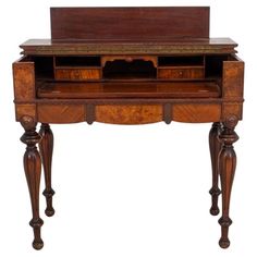 an old wooden desk with drawers on the top and two legs, inlaided with wood