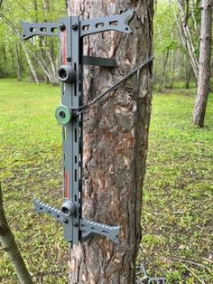 a bow that is attached to the side of a tree with two arrows on it