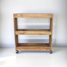 a wooden shelf sitting on top of a white floor