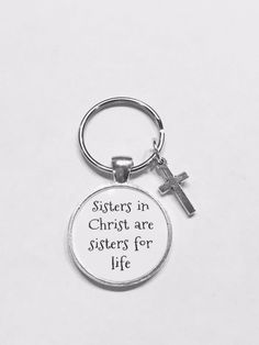 a keychain with the words sisters in christ are sisters for life on it