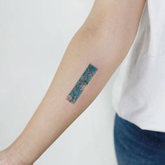 a woman's arm with a blue and white tattoo on the left side of her arm