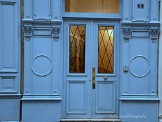 a blue building with two doors and windows