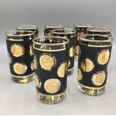 a set of six black and gold decorated glasses