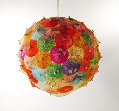 an umbrella that has been decorated with colorful leaves