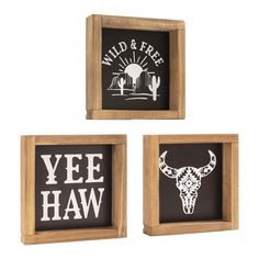 three wooden framed signs with the words wild and free on them, including an image of a cow skull