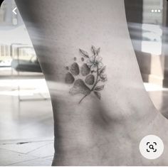 a foot with a flower and hearts tattoo on the side of it's leg