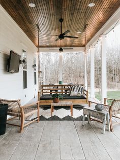 a porch covered with furniture and a flat screen tv