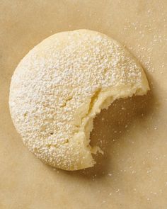 a doughnut that has been cut in half on top of a piece of parchment paper