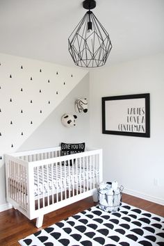 a baby's room with black and white decor