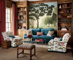 a living room filled with furniture next to a book shelf covered in lots of books