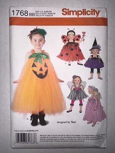 a child's halloween costume with pumpkins on it