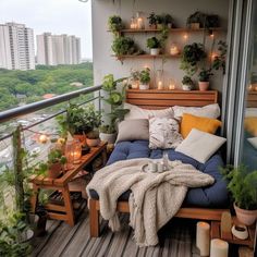 a balcony with potted plants and candles on the ledge, along with a couch