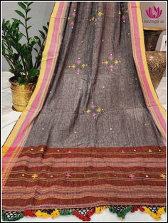 Look stylish and breezy in this summer boho style dupatta. Crafted from handloom Kala cotton for an extra soft feel, the dupatta features Gray body with embroidery and small mirror work. Brick color on both sides, giving it an extra touch of visual charm. The dupatta is finished with beautiful tassels for an elegant look. Please note: Color may vary slightly from the picture. Thread pulls, knots and few thread gaps are common in this type of dupattas and is not a defect. Very minor stains from t Cotton Dupatta With Mirror Work, Multicolor Cotton Dupatta With Embroidered Border, Cotton Dupatta With Mirror Work In Traditional Drape, Traditional Cotton Dupatta With Mirror Work, Bohemian Dupatta With Woven Motifs For Festive Occasions, Bohemian Cotton Dupatta For Festive Occasions, Bohemian Cotton Traditional Wear With Handloom Detail, Bohemian Handloom Cotton Traditional Wear, Bohemian Cotton Handloom Traditional Wear