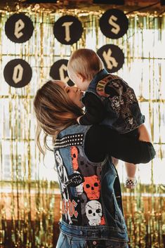 a woman holding a baby in her arms and kissing it's face with the words bits on them