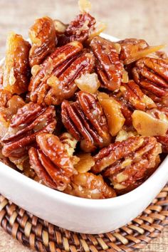 a white bowl filled with nuts on top of a table