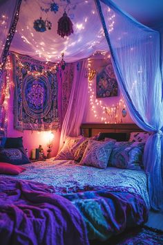 a bed covered in purple blankets and lights