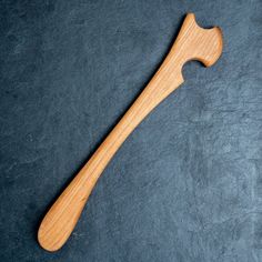 a wooden handle on a gray surface