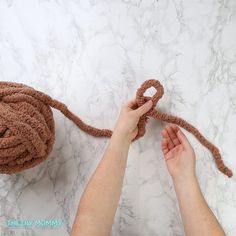 someone is crocheting a ball of yarn to make a stuffed animal that looks like a monkey