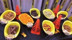 a table topped with yellow bowls filled with candy