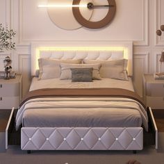 a white bed sitting under a large clock mounted to the side of it's wall