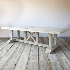 a wooden table sitting on top of a hard wood floor