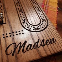 a wooden board with the word madeon engraved on it, sitting on a table