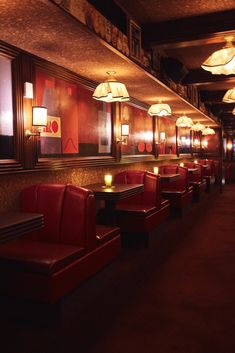 a dimly lit restaurant with red leather booths