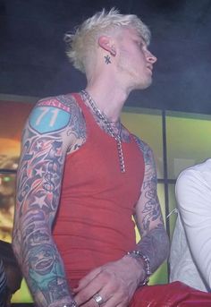 a man with tattoos on his arms and chest