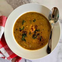 a white bowl filled with soup on top of a table