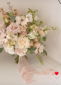 a bridal bouquet with pink and white flowers