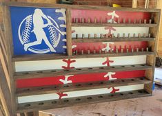 a wooden rack with baseballs and other sports related items on it's sides