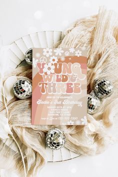 an image of a birthday party with disco balls and streamers on the table in front of it