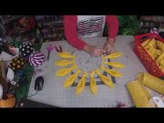 a woman is cutting bananas with scissors on a table in front of other items and decorations