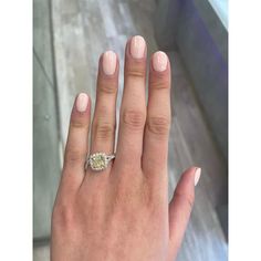 a woman's hand with a diamond ring on it