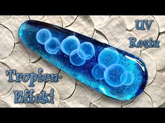 a blue object with bubbles on it and the words tropifer - effekt