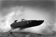 an old photo of a speed boat in the water