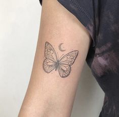 a woman's arm with a butterfly tattoo on the left side of her arm