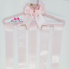 a pink hanger with a bow on it