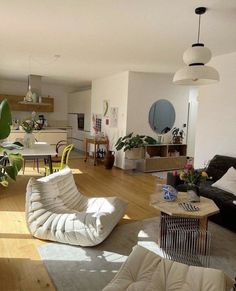 a living room filled with furniture and lots of windows