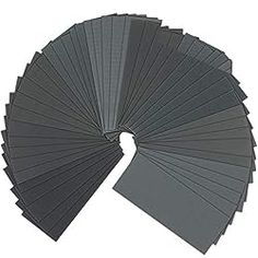 several different shades of gray paper arranged in a circle on top of eachother