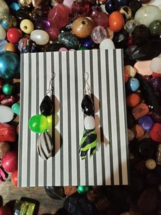 Beetlejuice inspired earrings. Repurposed, handmade, unique, and one of a kind. Funky Handmade Dangle Jewelry, Funky Adjustable Dangle Earrings, Quirky Multicolor Dangle Jewelry, Quirky Handmade Multicolor Earrings, Handmade Artsy Earrings For Party, Quirky Multicolor Handmade Earrings, Hand Painted Dangle Earrings For Party, Handmade Green Whimsical Earrings, Green Artsy Earrings For Party