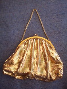 "High quality shimmering evening purse/handbag with gold chain , made well and heavy. Known for well manufactured and quality handbags. Dimensions: 5\" high x 6\" long x 2-1/2\" wide. Excellent condition, well lined in satin has a pocket with a mirror in it. You can dress this purse up or down with any outfit. However this one is red carpet ready. Very Antique looking. Very in style now! A conversation piece for sure! Makes for a great Christmas gift! Thank you for shopping at the Chuckle Patch Gold Evening Bag With Chain Strap, Gold Clutch Evening Bag For Cocktail, Chic Gold Cocktail Bag, Chic Gold Cocktail Bags, Gold Rectangular Clutch For Cocktail, Gold Rectangular Cocktail Clutch, Vintage Gold Handheld Clutch, Gold-tone Pouch Evening Bag, Gold Pouch Evening Bag With Gold-tone Hardware