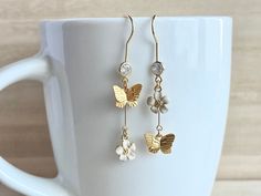 These dainty butterfly earrings with flowers are made of the followings: (1) Matt gold plated butterfly charm (Size: 8 x 10mm) (2) gold plated enamel flowers charm (size: 9 x 8mm) (3) gold plated earring hooks with cubic zirconia The total length of the earrings is about 47mm. ✏️ Please choose your desired color of flower 【BEFORE PURCHASE, PLEASE NOTE THE FOLLOWINGS】 ☆ VAT, GST and any other taxes from your country are NOT included in the listing price. Buyers are responsible for any aforesaid t White Dainty Butterfly Earrings, Dainty White Butterfly Earrings, White Butterfly Charm Earrings For Wedding, Ring Charm Necklace, January Birthstone Rings, Cute Butterfly, Butterfly Jewelry, Diamond Charm, Enamel Flower