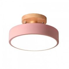 a pink ceiling light with wooden accents on the top and bottom part of the light fixture