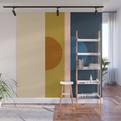 a living room with a wall painted in different colors and shapes, including an orange circle