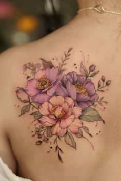 a woman's back with flowers and leaves on it