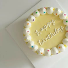 a birthday cake with white frosting and colorful sprinkles on it that says happy birthday