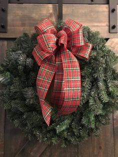 a red and green wreath with a bow