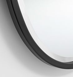 a black and white mirror hanging on the wall