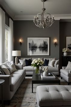 a living room filled with lots of furniture and a chandelier hanging from the ceiling